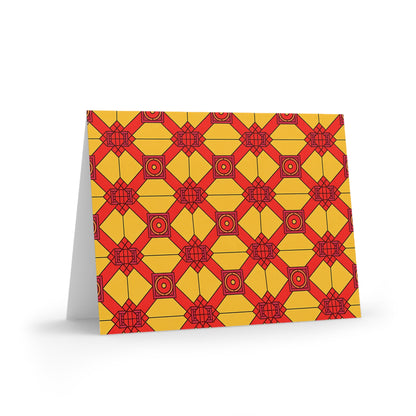 A folded card featuring a culturally inspired design with red geometric lines forming interconnected diamonds and rectangles on a yellow background. This premium stationery stands upright, revealing its partially visible white inner side.