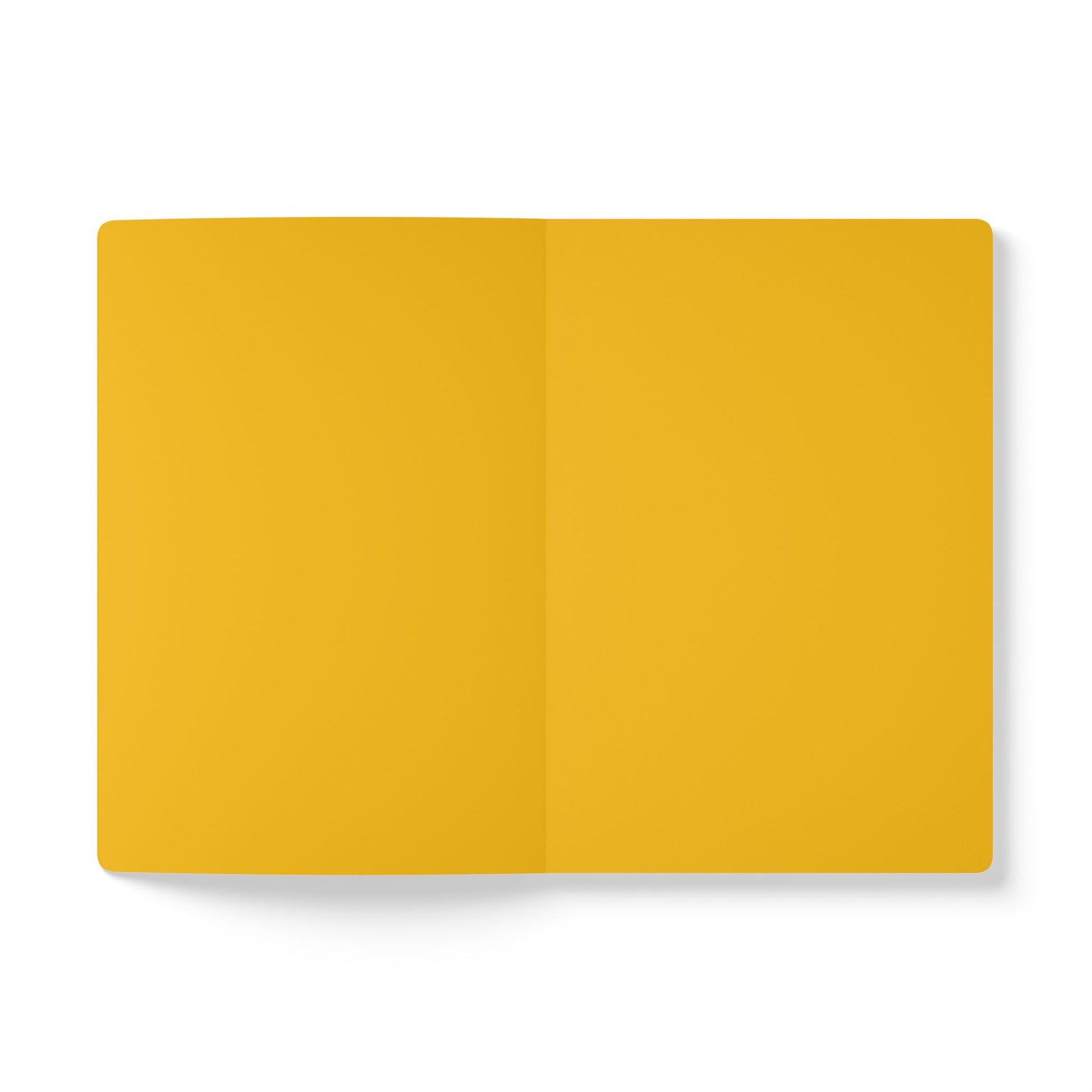 An open, blank African-inspired journal with yellow pages lies flat against a white background. The pages are completely empty, with a visible crease down the center and a shadow on the left, perfect for daily journaling or creative reflection.