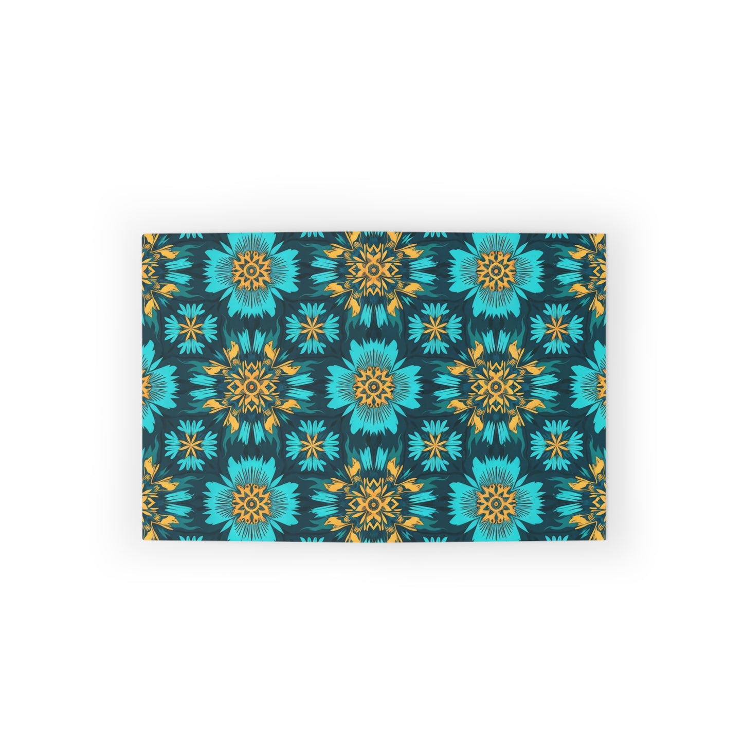 Rectangular mat with a vibrant, symmetrical floral pattern showcasing culturally inspired designs. Teal blue and yellow flowers create a lively geometric motif on a dark background. The mat is centered on a white surface.