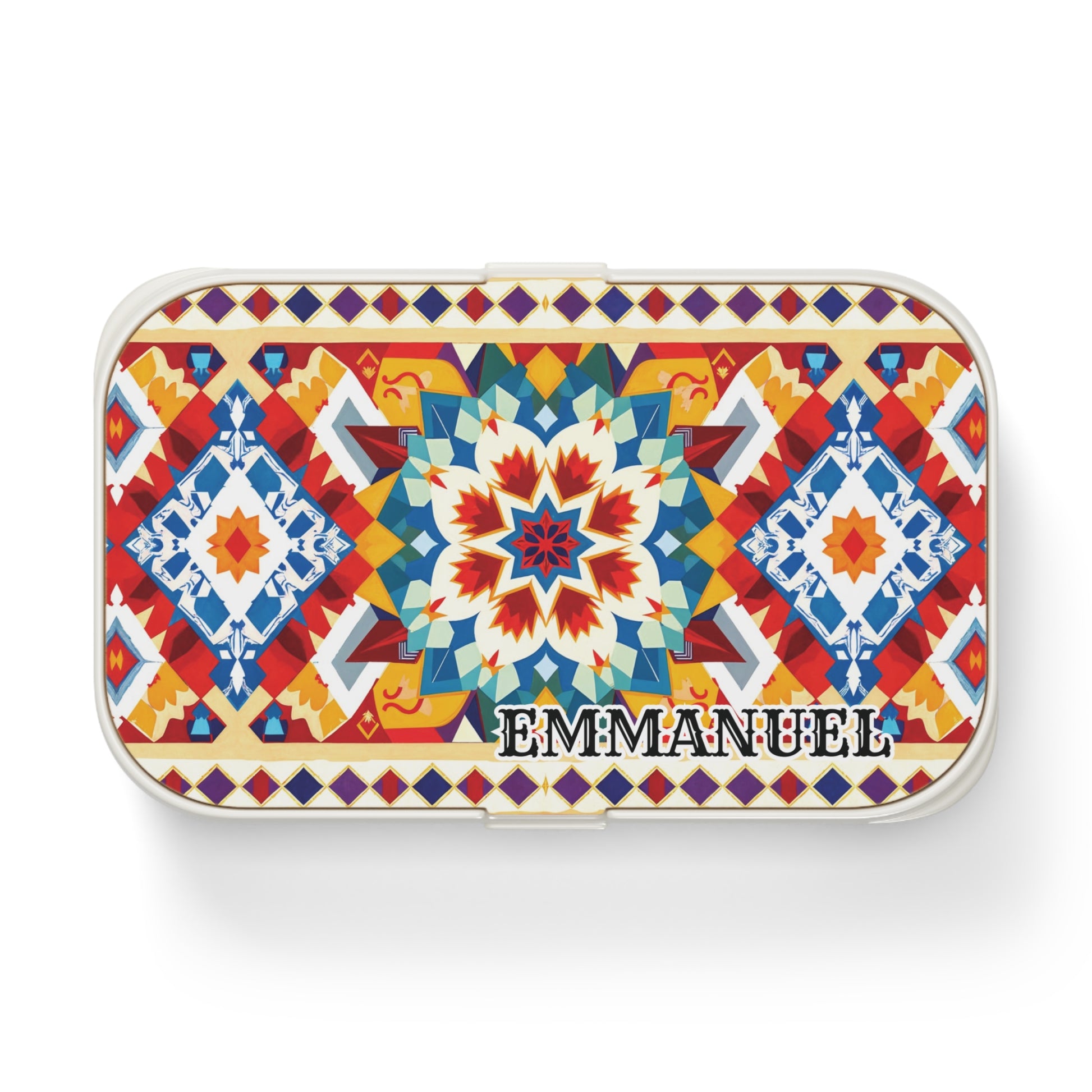A rectangular, African-inspired bento lunch box featuring a vibrant geometric mosaic in red, blue, yellow, and white. “EMMANUEL” appears boldly on the lower right corner of this stylish, personalized lunch box.