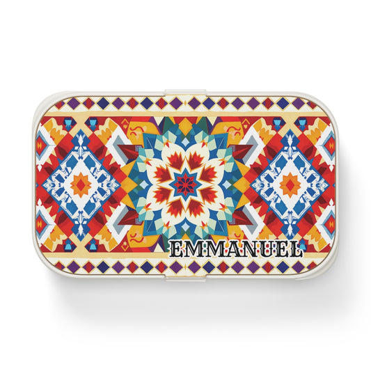 A rectangular, African-inspired bento lunch box featuring a vibrant geometric mosaic in red, blue, yellow, and white. “EMMANUEL” appears boldly on the lower right corner of this stylish, personalized lunch box.