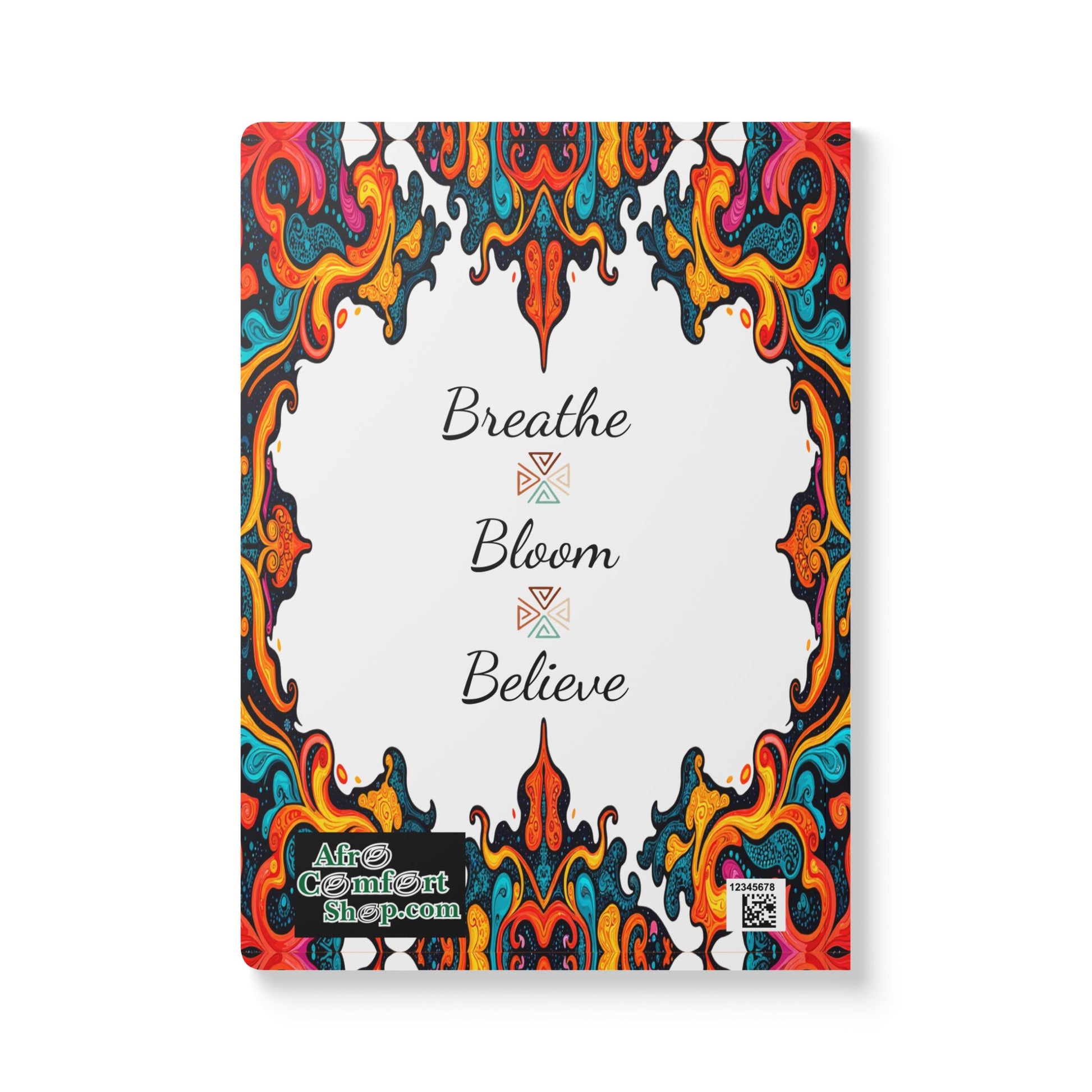Notebook cover with ornate, colorful, swirling patterns framing a white center. In the center, black script reads “Breathe Bloom Believe.” Perfect as an African-inspired journal for daily journaling. Alfa Comfort Shop logo and QR code included.