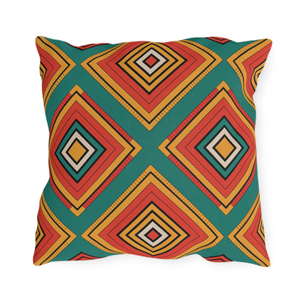 A square outdoor pillow featuring a bold geometric diamond pattern. Layered in vibrant colors against a teal background, its symmetrical design is lively and modern. Crafted from weatherproof materials, its perfect for adding style outdoors.