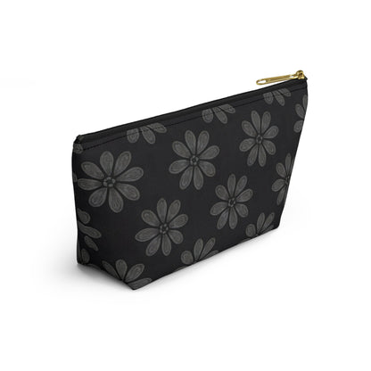 A black zippered T-bottom pouch featuring large, stylized gray flowers with multiple petals in an African-inspired pattern. The cosmetic travel bag has a gold zipper and is photographed against a white background at a slight angle.