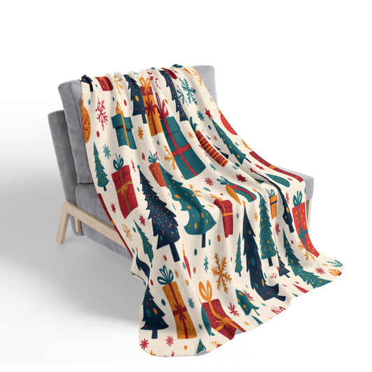 A cozy chair draped with a festive blanket featuring African-inspired Christmas trees, gift boxes, and snowflakes on a white background. The cheerful holiday-themed design adds warmth and seasonal charm to the setting.