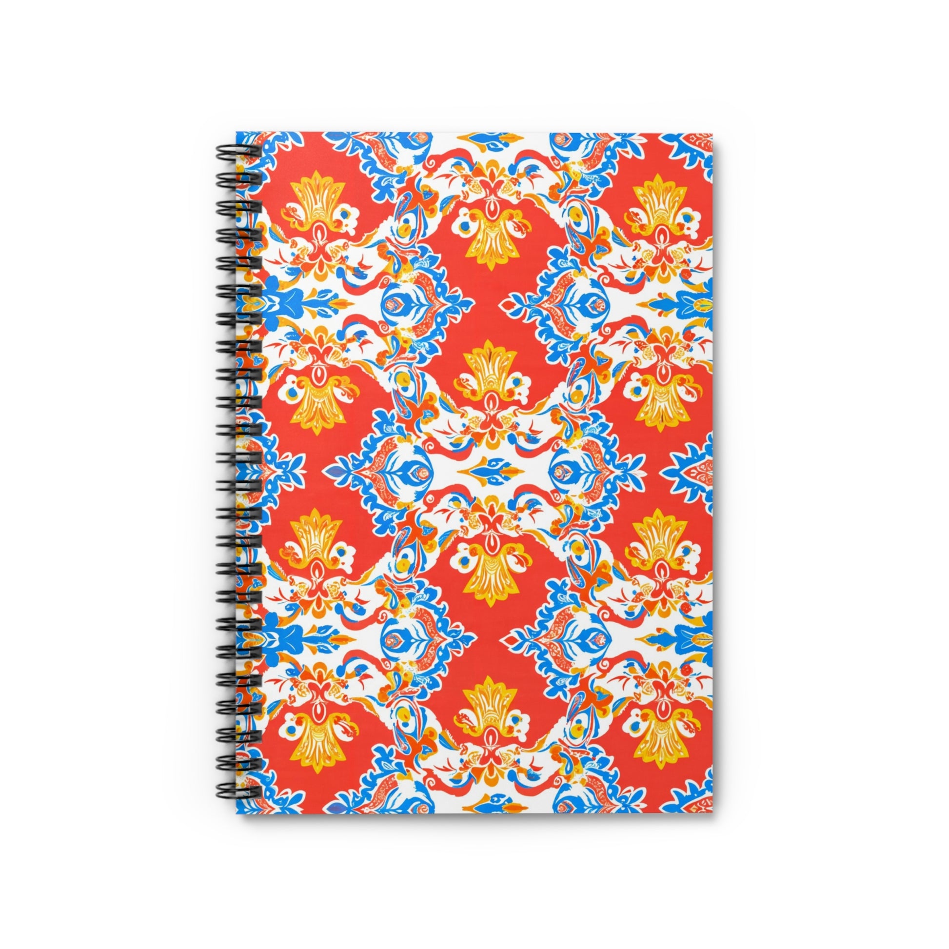 A spiral-bound notebook with a vibrant cover featuring culturally inspired designs—an ornate, symmetrical pattern of red, yellow, blue, and white floral swirls. The lively red background creates an eye-catching look for this premium writing notebook.