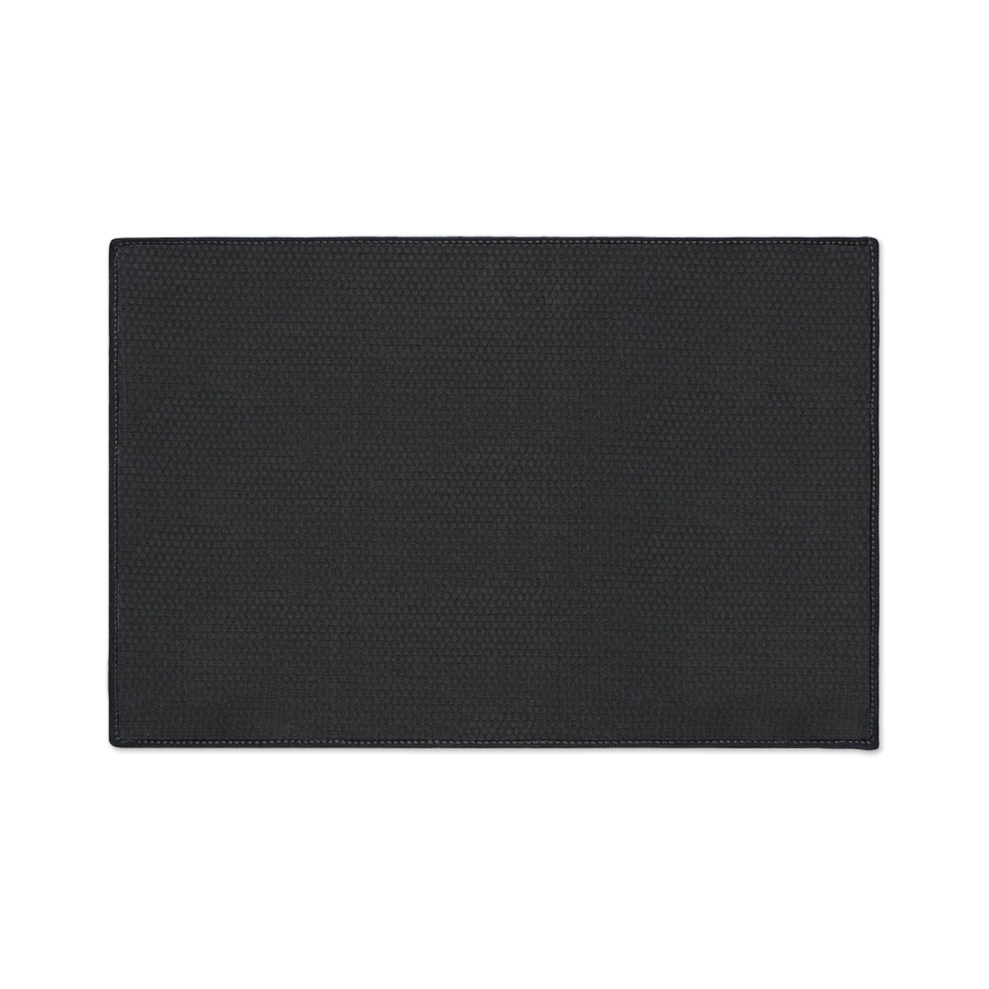 A rectangular black placemat with a subtle textured pattern and slightly rounded edges is shown on a white background. The design features visible stitching along the border and a small, repeating geometric or honeycomb detail, perfect for African-inspired décor.