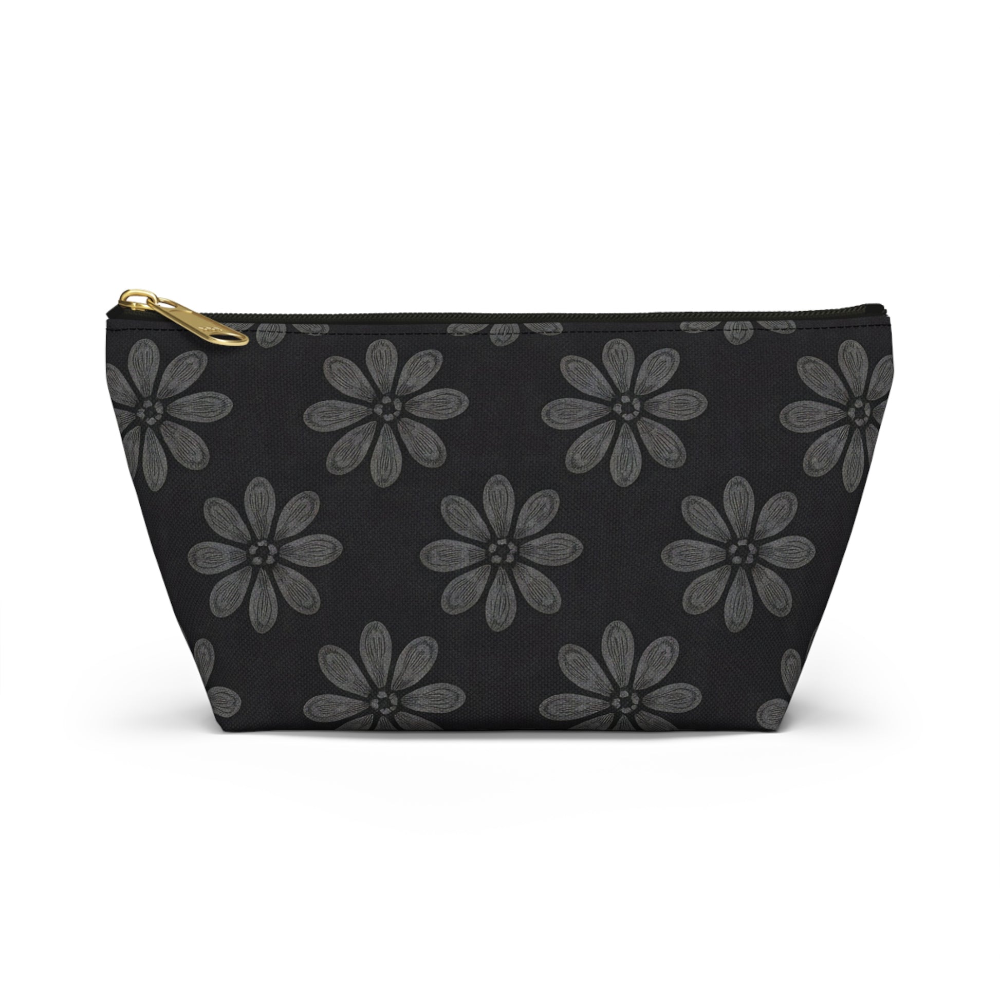 A black cosmetic travel bag with a gold zipper, featuring African-inspired patterns of large, gray, six-petaled flowers evenly spaced across the solid black T-bottom pouch. Displayed upright against a white backdrop.