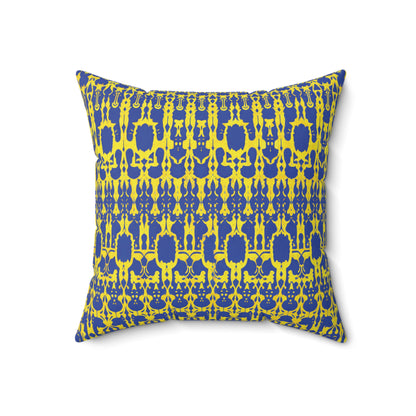 A square African accent pillow featuring a vibrant geometric pattern in blue and yellow. The symmetrical, abstract shapes create a bold, modern look. Photographed against a white background, the colorful faux suede pillow stands out beautifully.