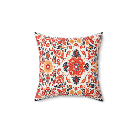 Square faux suede pillow with a vibrant floral pattern in red, orange, yellow, and black on a white background. Symmetrical flowers and leaves create an eye-catching African accent pillow, shown against a plain white backdrop.