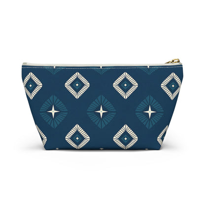 A blue zippered pouch with African-inspired geometric diamond patterns in white and teal. Perfect as a cosmetic travel bag, it features a central starburst design, white zipper with brass pull, and sits upright against a white background.