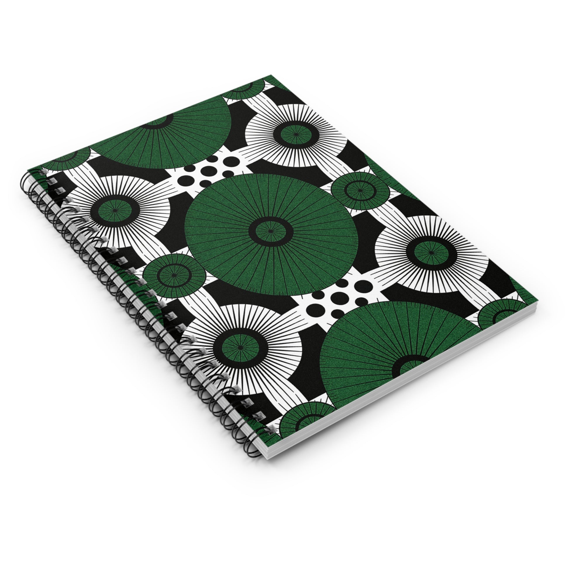 An African-inspired spiral notebook with a cover design of large green circles, black and white accents, and polka dots on white. Positioned at an angle, it features a front cover and spiral binding for a premium writing experience.