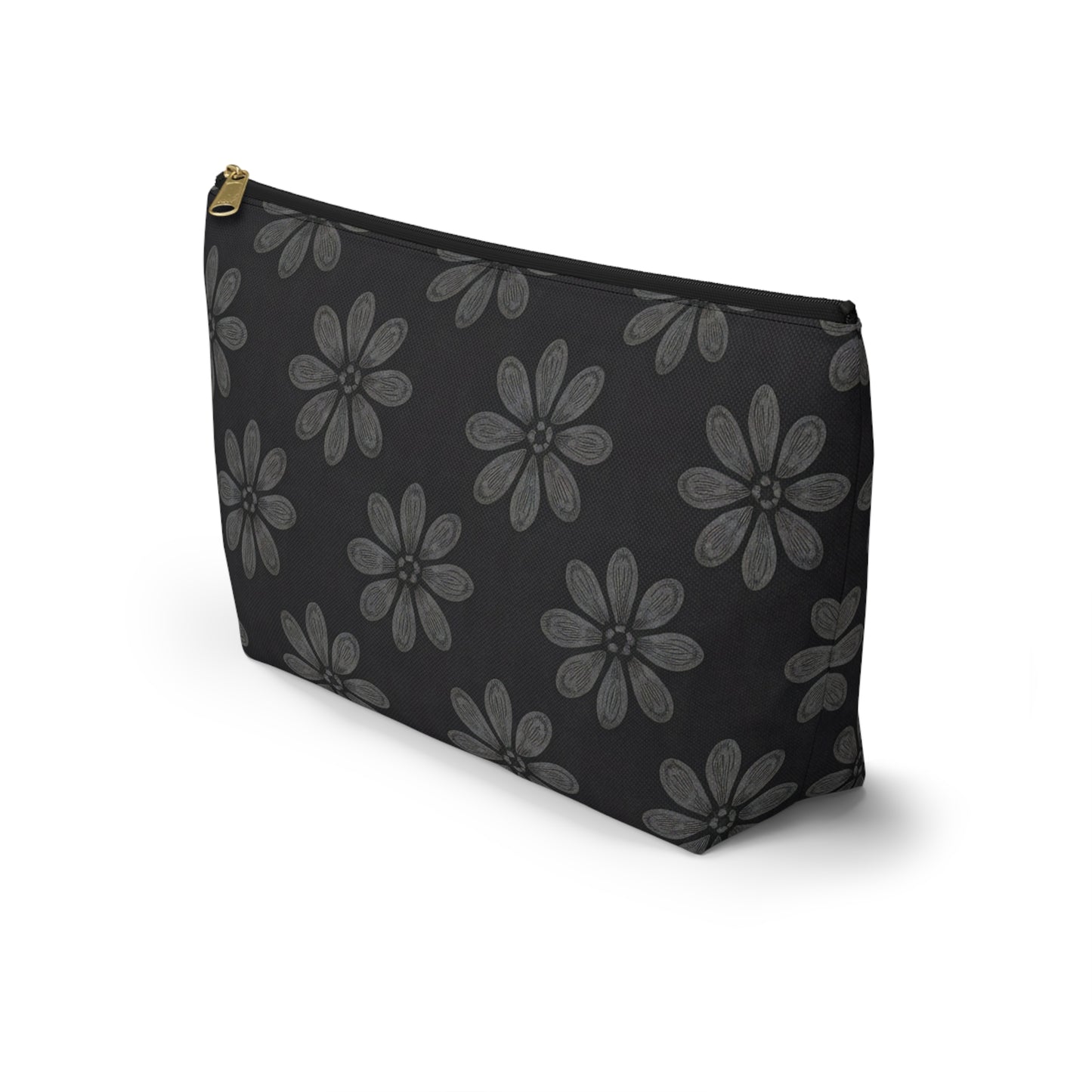 A black T-bottom pouch with large gray, African-inspired floral patterns—each flower boasting eight textured petals. The gold-colored zipper adds elegance, making this cosmetic travel bag stand upright on a white background.