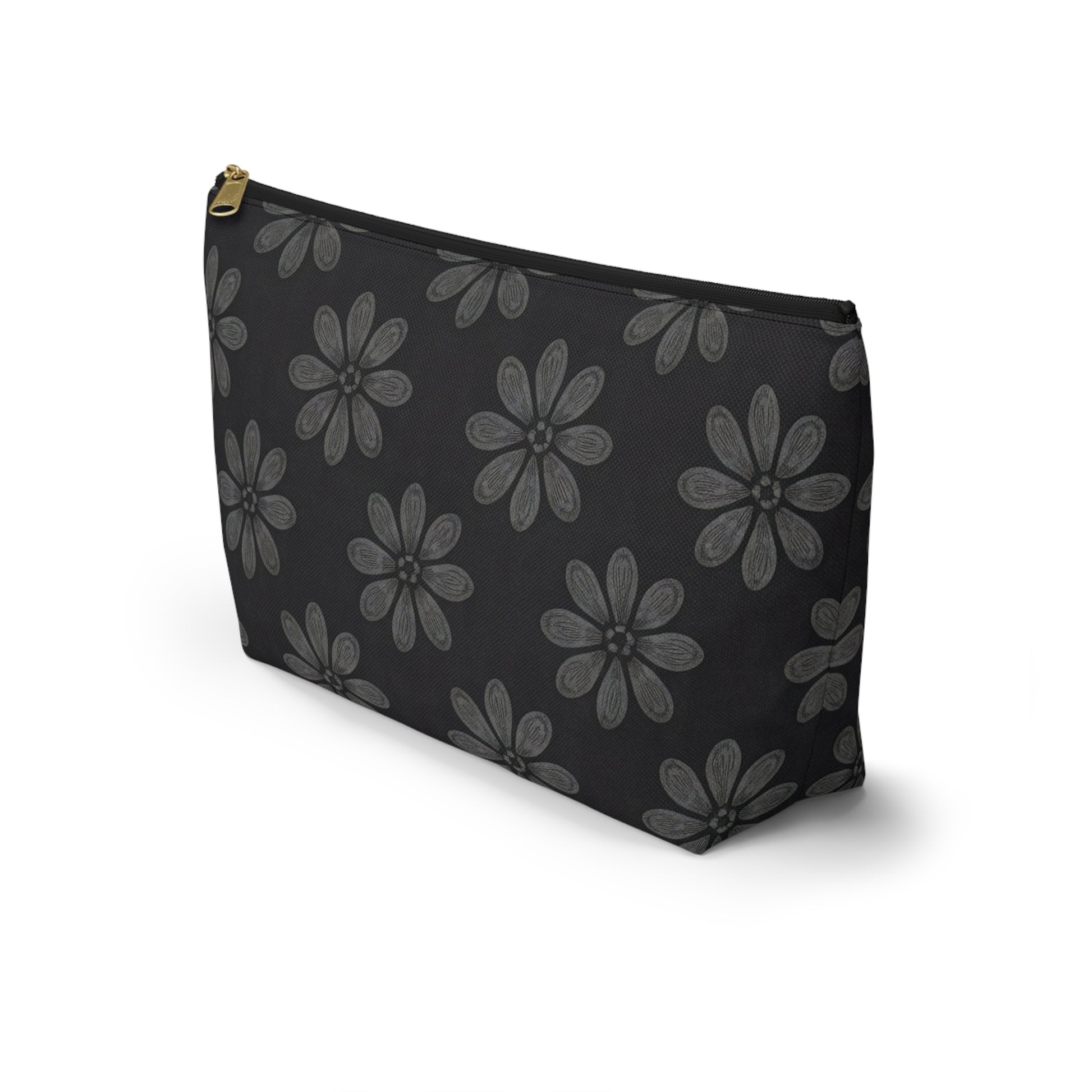 A black T-bottom pouch with large gray, African-inspired floral patterns—each flower boasting eight textured petals. The gold-colored zipper adds elegance, making this cosmetic travel bag stand upright on a white background.