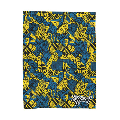 A vibrant African-inspired blanket features a bold geometric pattern in yellow, blue, and black, with abstract shapes, lines, and animal motifs. In the lower right corner, “Effiong” is stylishly written, making this a stunning personalized velveteen blanket.