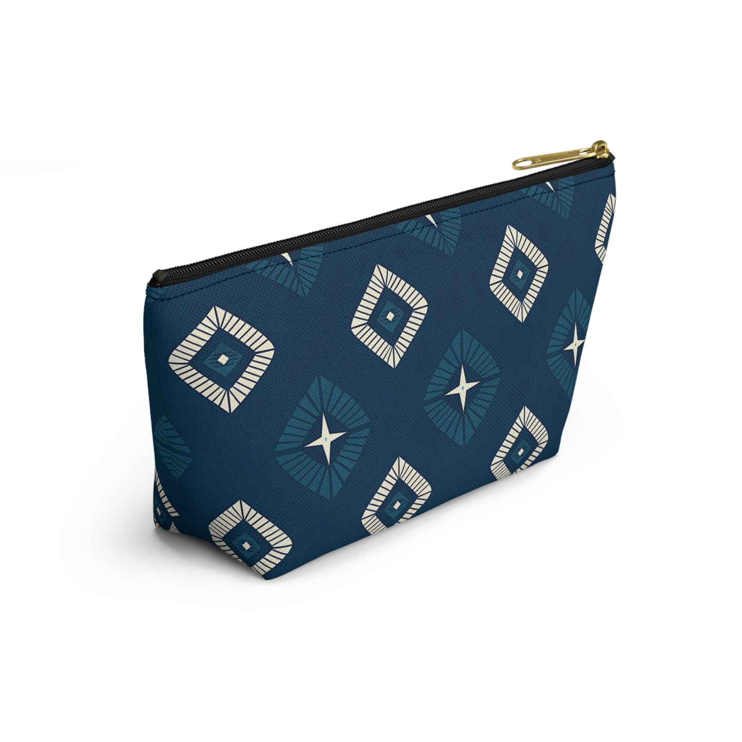 A blue cosmetic travel bag with a gold zipper, featuring African-inspired patterns in a geometric diamond design of white and navy. The T-bottom pouch stands upright, displaying radiating lines and star shapes at each center against a white background.