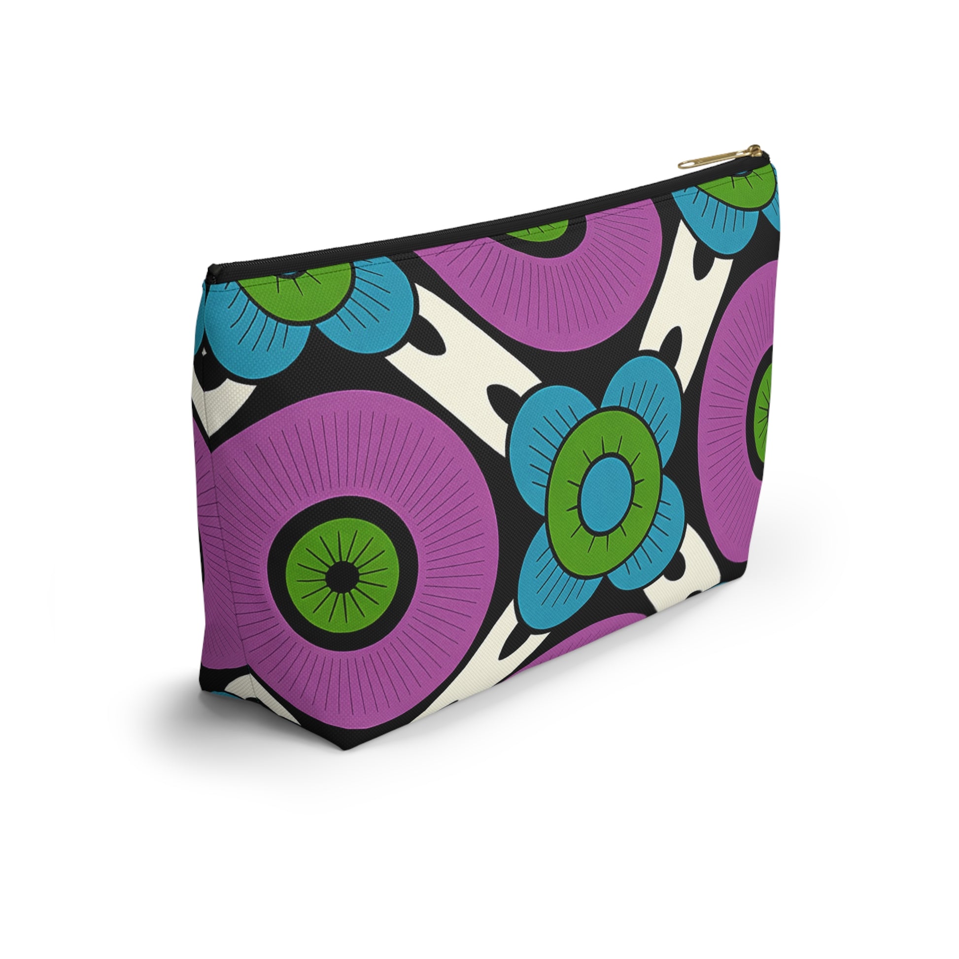 A zippered T-bottom pouch with a bold, African-inspired floral pattern featuring large purple, green, and blue flowers outlined in black on a white background. The pouch stands upright, showing its rectangular shape and gold zipper.