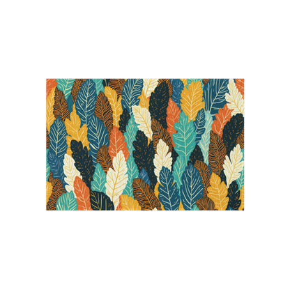 A colorful, seamless pattern of overlapping leaves in shades of teal, mustard yellow, orange, navy blue, and cream. Each leaf is outlined with fine lines, creating a dense and vibrant African-inspired botanical design on a white background.