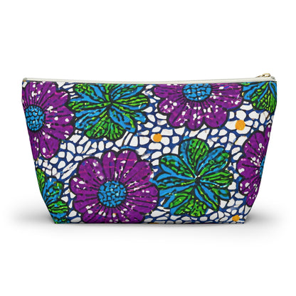 A zippered T-bottom pouch with a bold floral pattern. Large purple and green flowers with blue and yellow accents cover the white background, which features an abstract black dot design. Perfect as a cosmetic travel bag for vibrant organization.