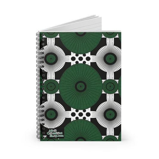 A spiral-bound notebook with a bold, African-inspired geometric pattern of green circles, black and white concentric shapes, and black dots on white. The bottom left reads “The Content Shop” in white, celebrating culturally inspired designs.