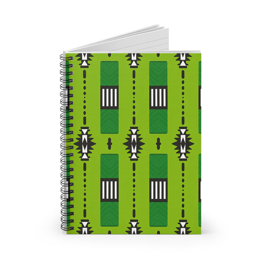 A geometric spiral notebook with a bright green cover, featuring an African inspired pattern of black, white, and dark green rectangles, chevrons, and dotted lines in vertical rows. The notebook stands upright, slightly open.