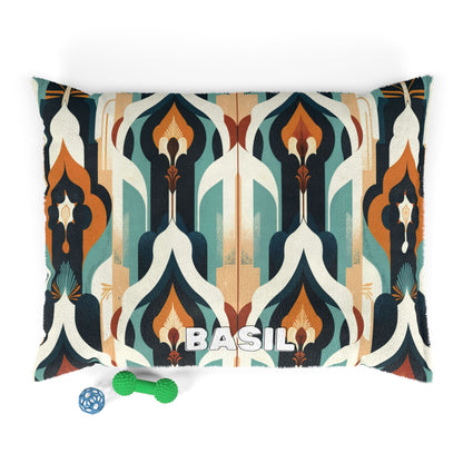 A cozy pet bed with a retro geometric pattern in teal, orange, cream, and brown. BASIL is printed boldly on the front of this personalized pet bed. Next to it are a green textured chew toy and a blue ball-shaped toy.