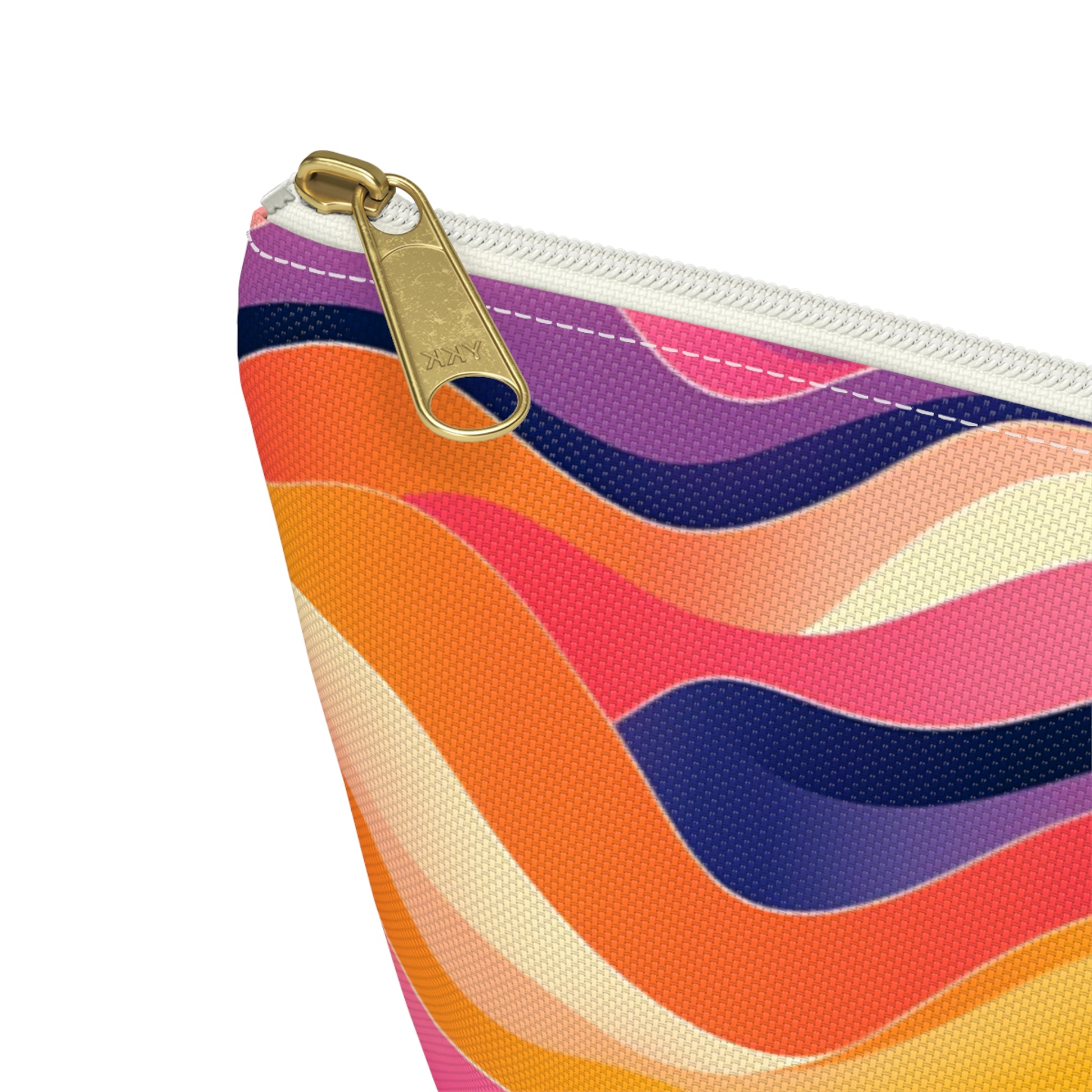 A close-up of a T-bottom pouch with a gold zipper. The fabric showcases vibrant, African-inspired patterns in shades of orange, pink, purple, cream, and navy blue. The woven texture is clearly visible, adding depth to this stylish cosmetic travel bag.