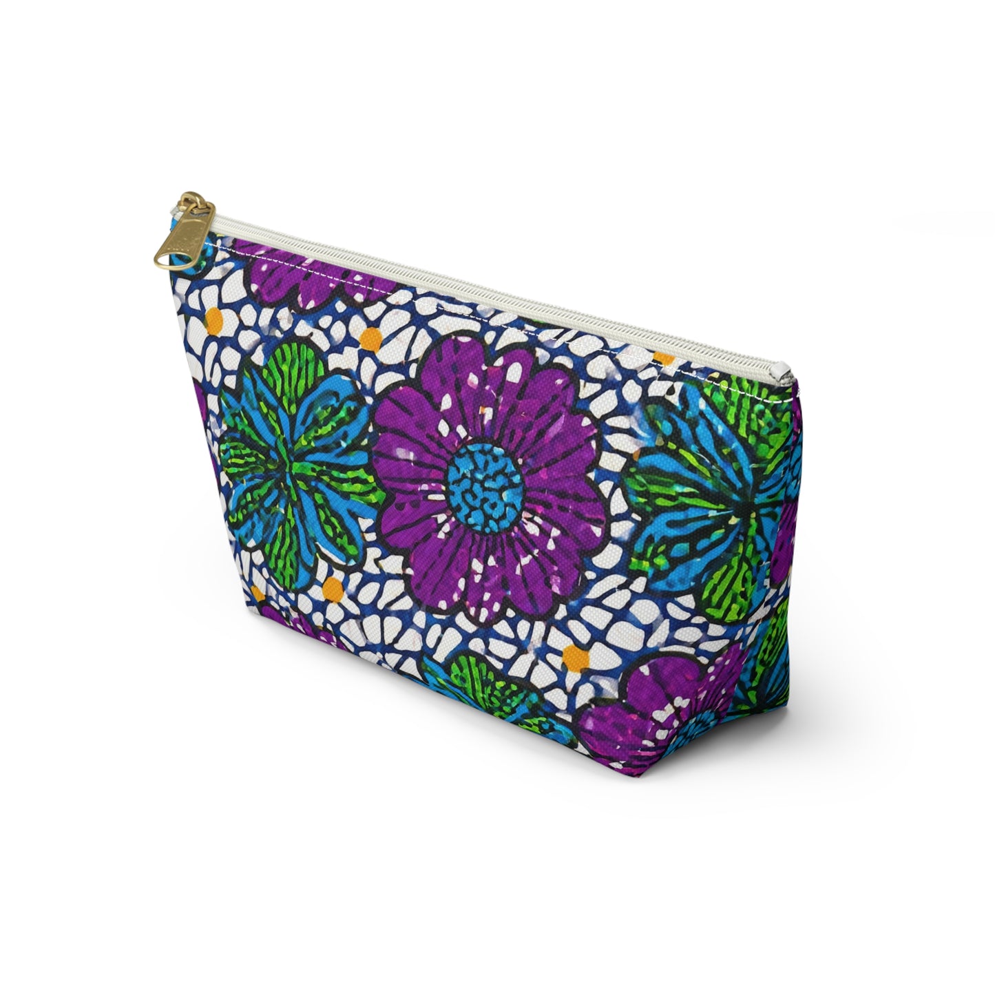 A zippered T-bottom pouch with a bold floral pattern in purple, blue, and green, outlined in black on white. This cosmetic travel bag stands upright and features African-inspired patterns with prominent flowers and a lace-like background.