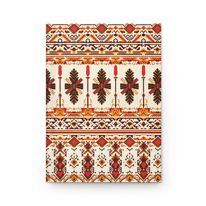 A rectangular canvas features a symmetrical, geometric tribal pattern in red, black, and yellow on a cream background. The design includes horizontal bands of repeating floral, diamond, and zigzag motifs, creating a vibrant look perfect for a hardcover journal.