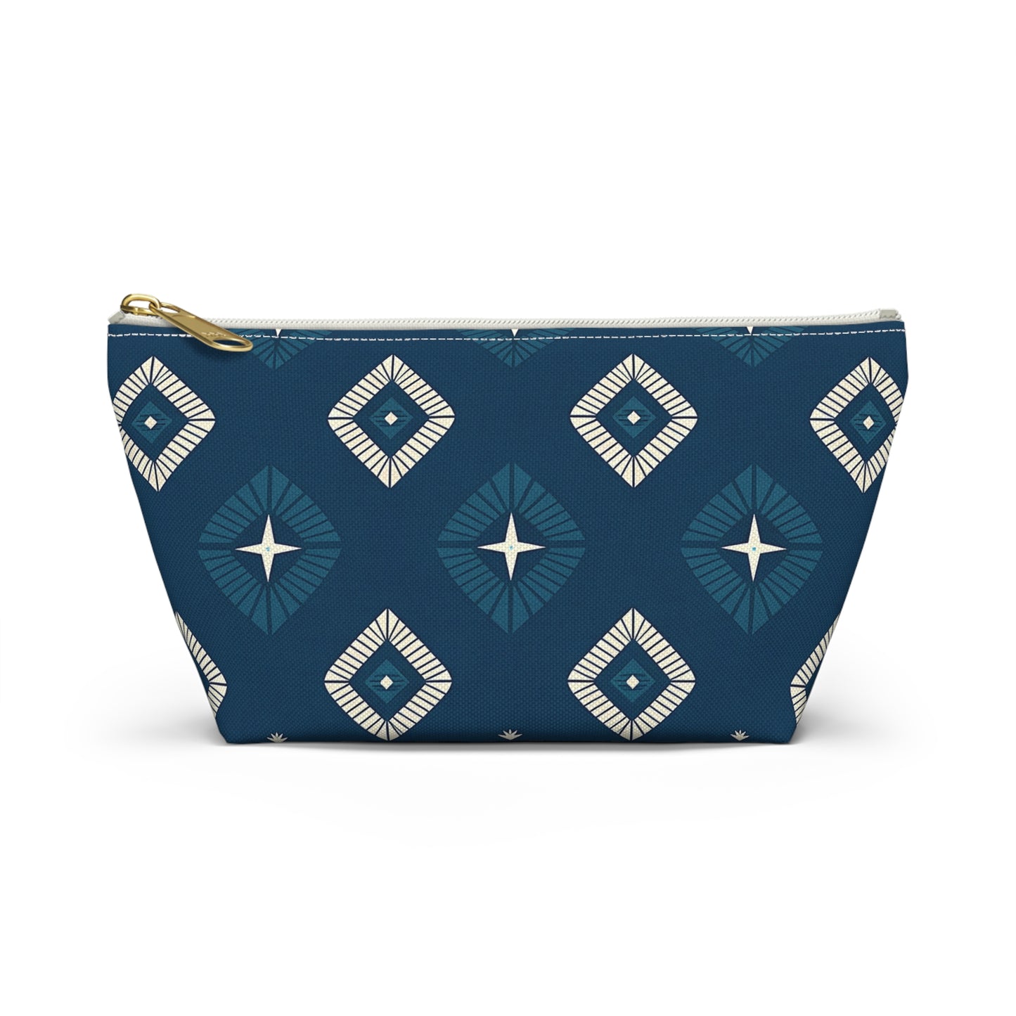 A T-bottom pouch with a brass-colored zipper, this cosmetic travel bag features African-inspired patterns of blue and white diamond shapes with star-like centers on a dark blue background. The trapezoid shape allows it to stand upright.