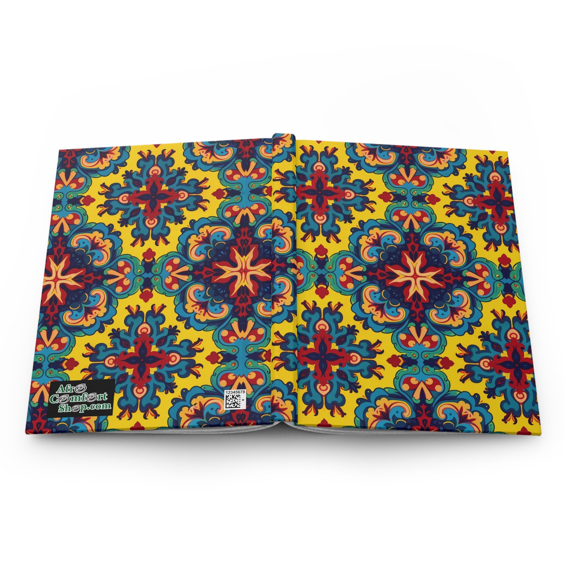 Open hardcover journal with a vibrant, symmetrical floral and geometric pattern in red, teal, and blue on a bright yellow background. A small logo and QR code are visible on the bottom left corner of this African-inspired journal.