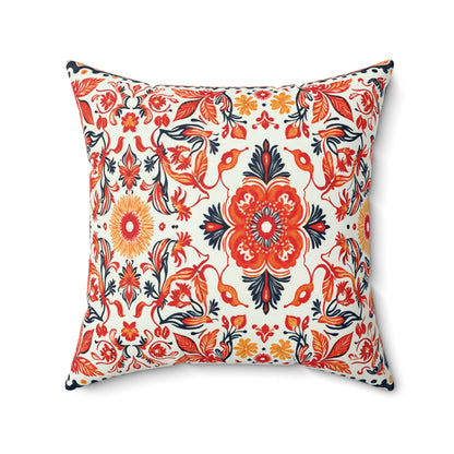 Square faux suede pillow with a vibrant floral pattern featuring red, orange, yellow, and navy blue flowers on white. This African inspired accent pillow showcases a large central bloom with smaller flowers and vines completing the lively design.