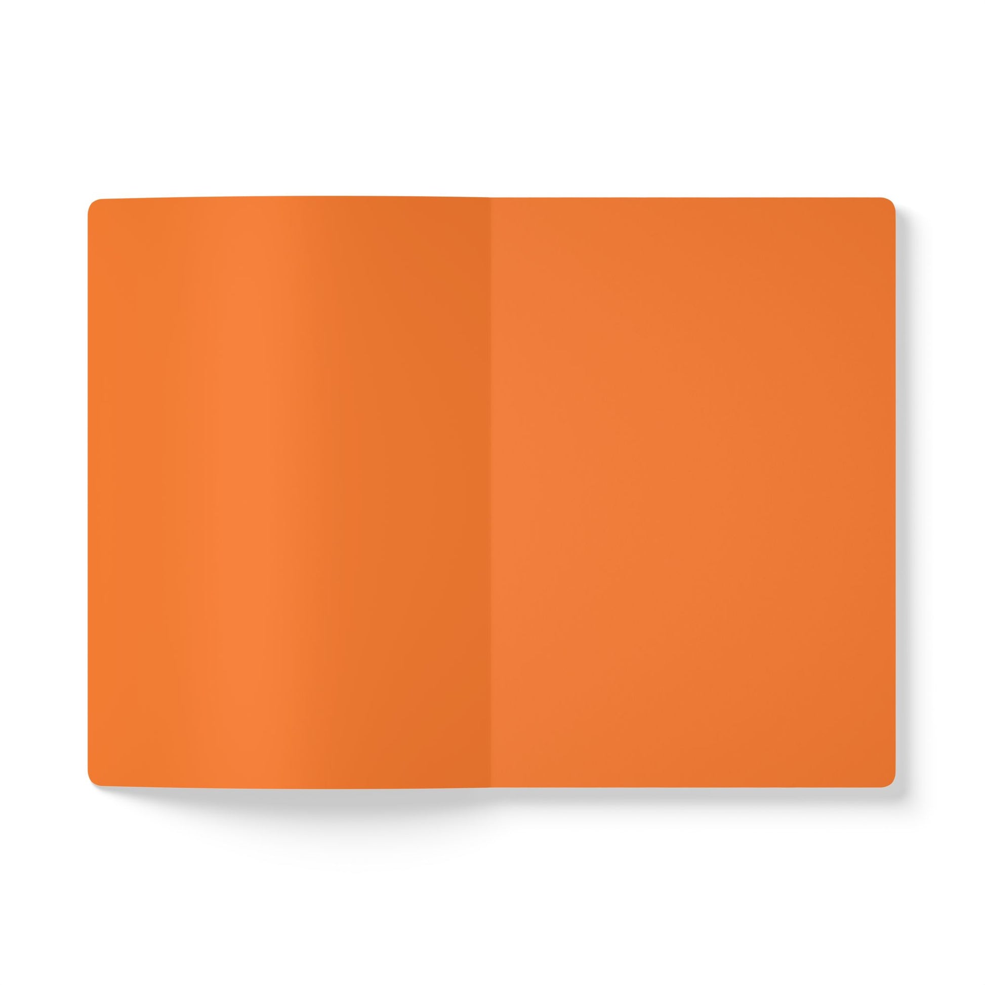 An open, blank creative notebook lies flat on a white surface. Both visible pages are a solid, bright orange color, with a subtle center crease. There are no markings or text, and the notebook casts a soft shadow to the left.