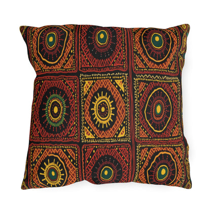 Square pillow with a bold, African-inspired geometric pattern in red, orange, black, and yellow. The design features repeating concentric circles and diamond shapes arranged in a grid, each bordered with intricate dotted and lined details.
