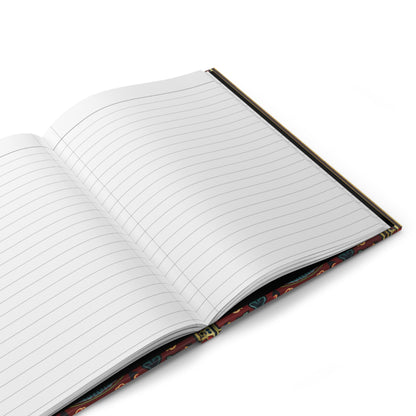 An open, lined writing journal is shown at an angle on a white surface. The pages are blank, and the cover features a decorative pattern with red, blue, and yellow accents along the edge. The notebook is ready for writing.