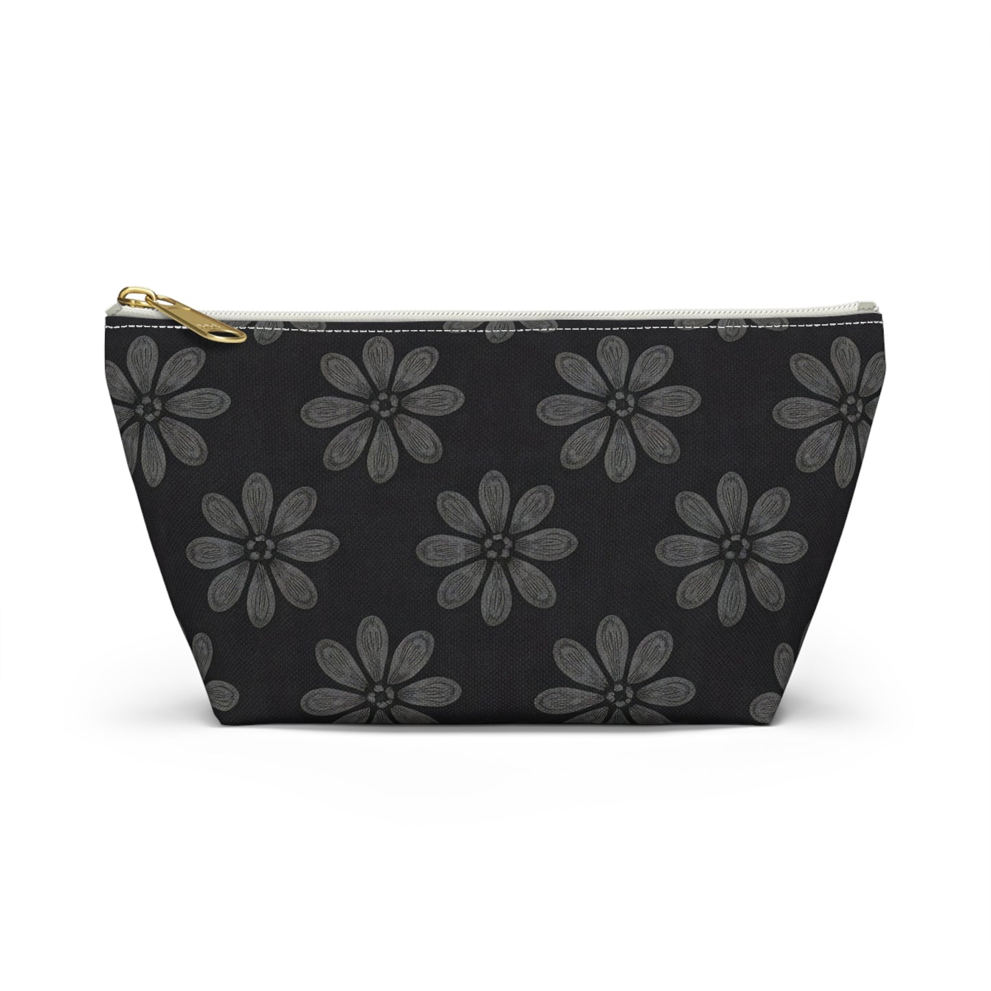 A black cosmetic travel bag with a gold zipper, featuring an African-inspired pattern of large, gray six-petal flowers. The T-bottom pouch's symmetrical floral design creates a strikingly elegant and organized appearance.