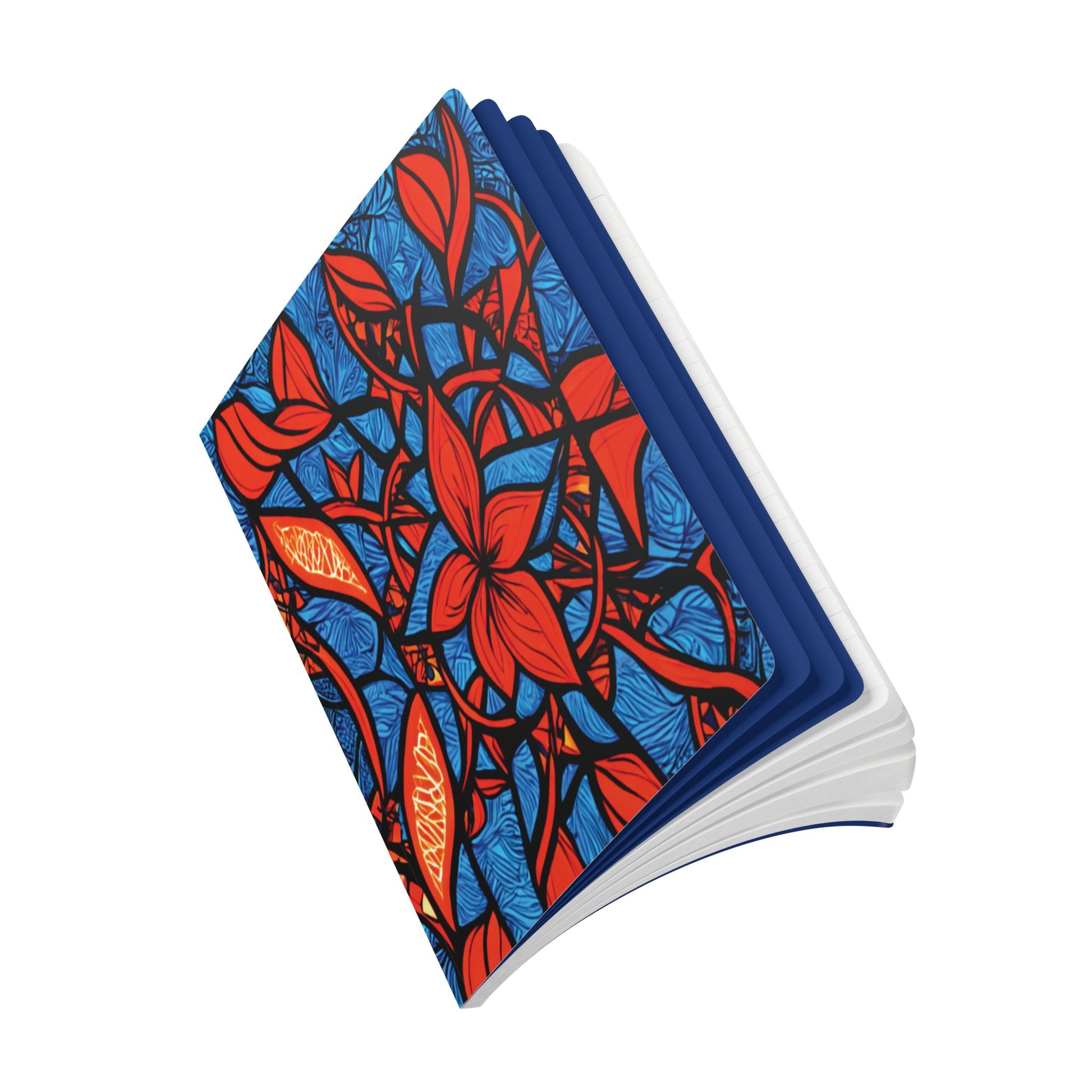A creative journal with a cover design featuring bold red flowers and leaves outlined in black, set against a blue background with abstract patterns. The book is open and viewed at an angle, showing white pages and a blue inner cover.