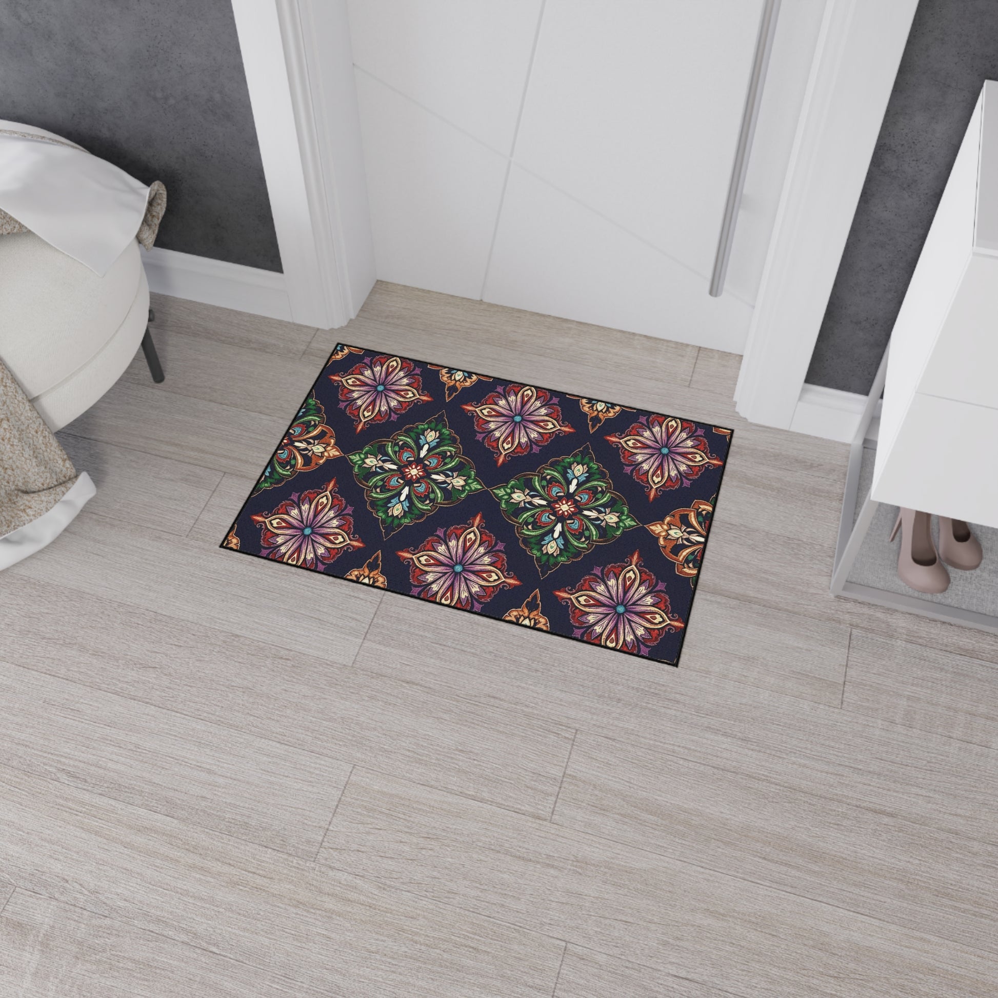 A colorful doormat with a geometric floral pattern in red, green, gold, and purple sits on light wood flooring at the entrance, adding an African-inspired home decor touch. Its non-slip rubber backing keeps it secure in this modern room.