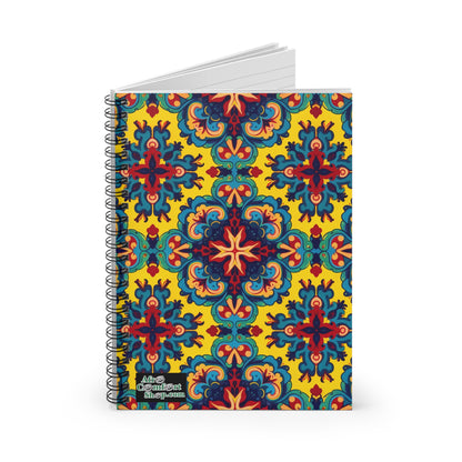 A premium writing journal with a vibrant cover featuring an intricate, symmetrical pattern in red, blue, green, and orange on a yellow background. The African-inspired spiral notebook has a small Artsy Gradient Shop.com label at the bottom left corner.