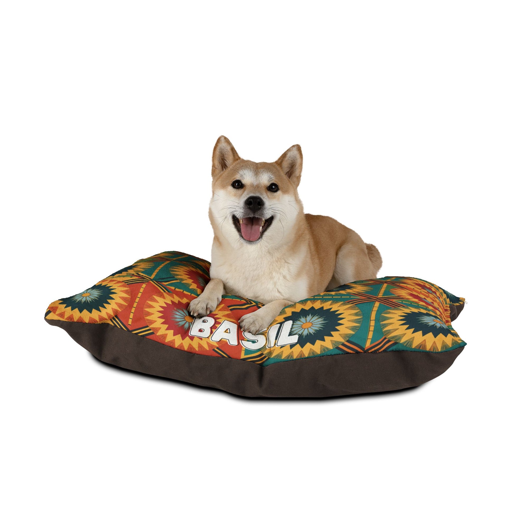 A Shiba Inu with tan and white fur sits happily on a colorful, personalized pet bed. Boasting starburst designs and the name BASIL on the front, this bed offers luxurious comfort, keeping the dog content with its mouth open and tongue out.