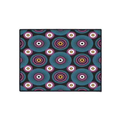 Rectangular mat with a repeating abstract pattern of concentric circles in vibrant hues on a black background. This African-inspired floor mat features a geometric, retro, kaleidoscopic effect and includes a non-slip rubber backing for added safety.