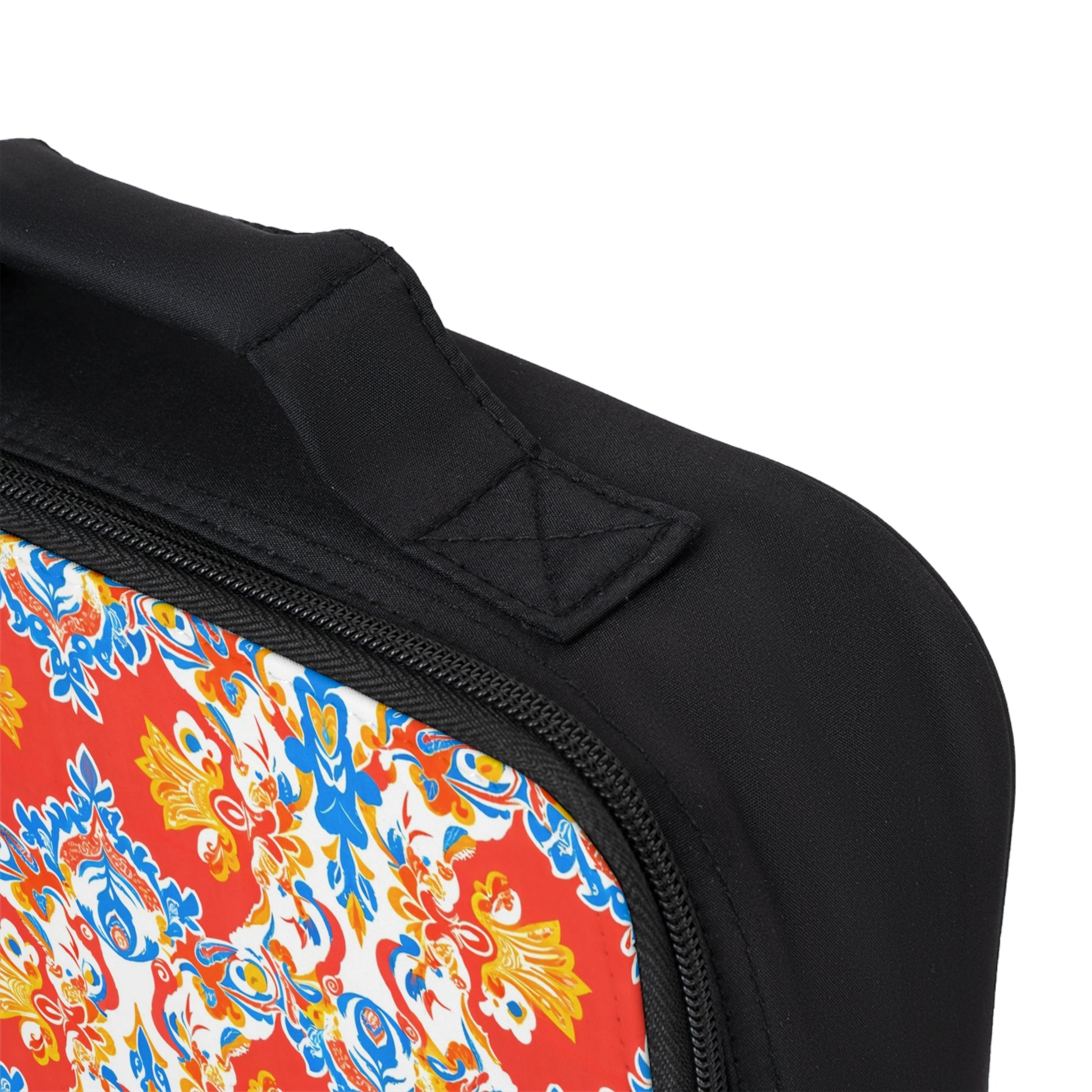 Close-up of an African-inspired personalized lunch bag’s corner, showing a black fabric handle, black zipper, and ornate floral pattern in vibrant hues. Visible stitching highlights the craftsmanship of this customizable lunch bag.