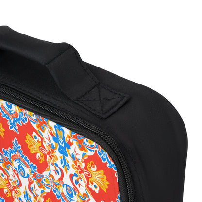 Close-up of an African-inspired personalized lunch bag’s corner, showing a black fabric handle, black zipper, and ornate floral pattern in vibrant hues. Visible stitching highlights the craftsmanship of this customizable lunch bag.