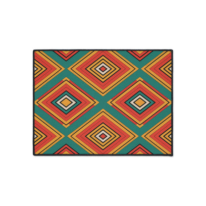 Rectangular mat with a bold geometric pattern of diamond shapes in orange, red, yellow, and teal arranged in rows. Featuring African-inspired aesthetics on a white background, this mat includes a black border and non-slip rubber backing for stability.