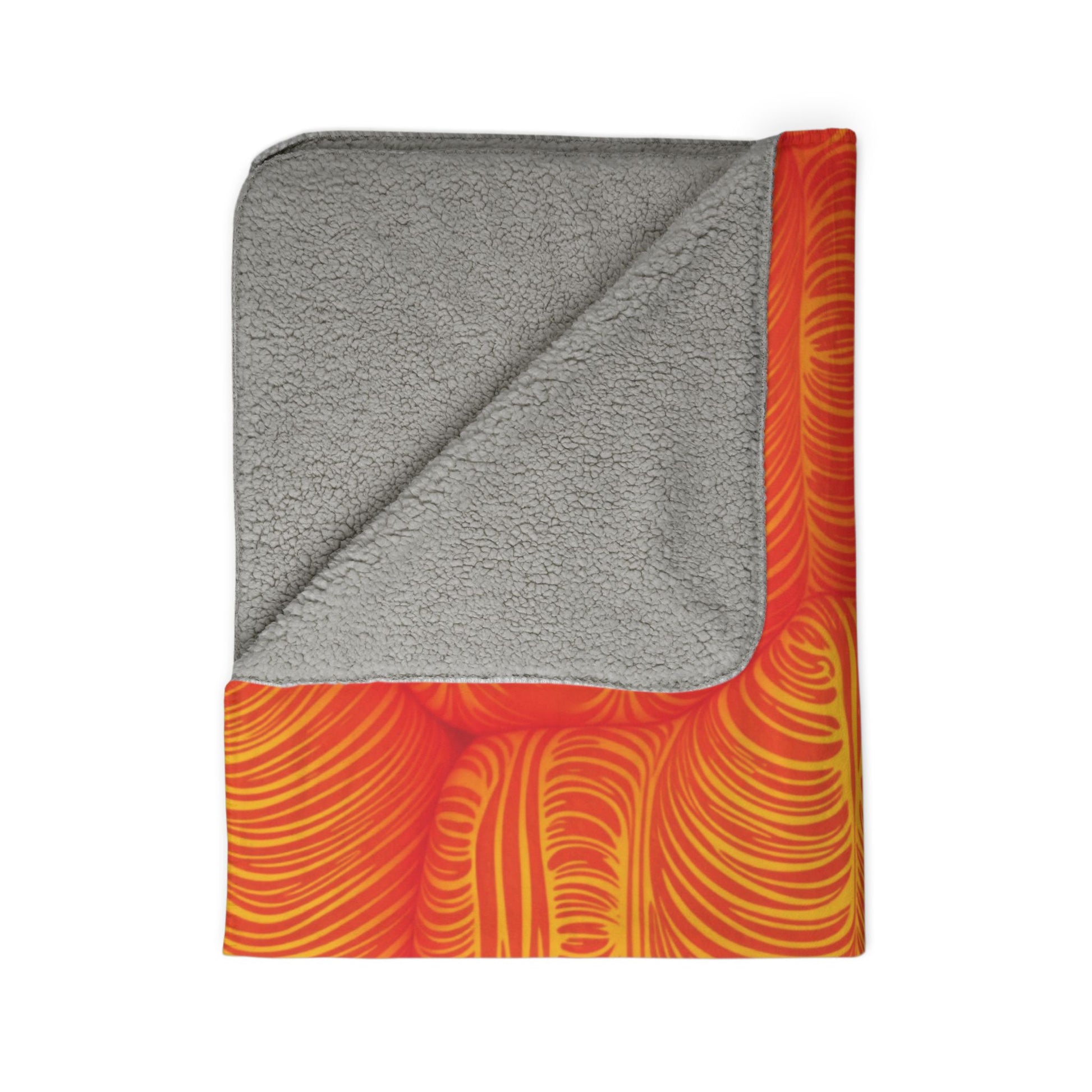 A folded sherpa fleece blanket with a soft, light gray sherpa lining on one side and a vibrant, abstract pattern of swirling orange and yellow lines on the other—perfect for adding cozy home decor to any space.