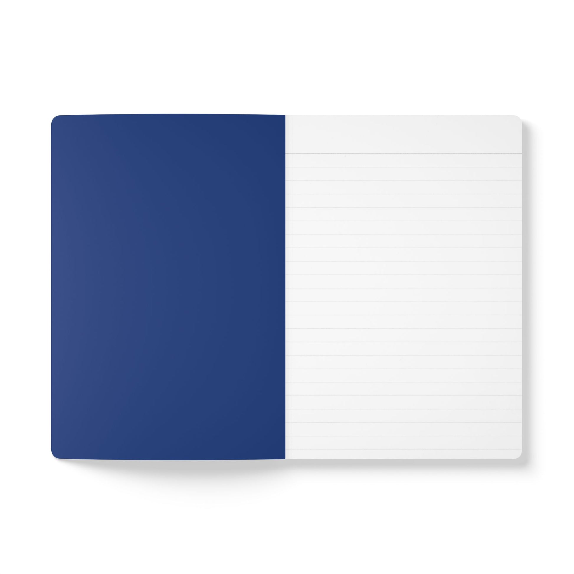 An open notebook lies flat on a white surface. The left page is solid dark blue, while the right page is white with light grey lines for writing. Its clean, minimalistic style makes it perfect for travel diary notes or creative journaling.