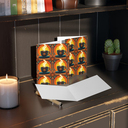 A blank card and pen rest on a dark wooden shelf, next to a lit candle and small potted cactus. Behind them, a card with a culturally inspired design of steaming coffee cups adds vibrancy, while books are stacked on the upper shelf.