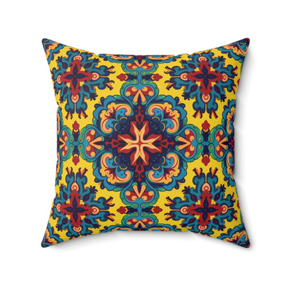 Square faux suede pillow with a vibrant, symmetrical pattern. The yellow background features intricate blue, red, teal, and orange shapes radiating from a central starburst, blending Mediterranean tilework with the bold flair of an African accent pillow.