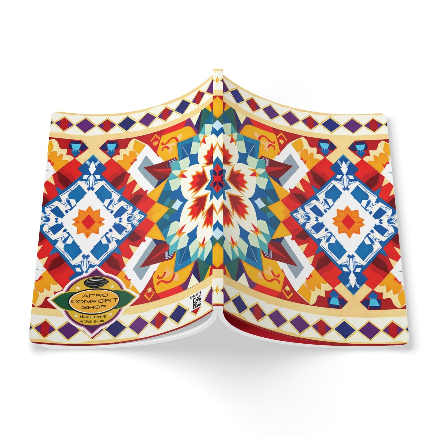 A vibrant African-inspired journal with a geometric, multicolored cover in red, blue, yellow, and white. Diamond shapes and symmetrical motifs stand out, and a gold Afro Comfort seal accents the bottom left. The book is shown open, facing down.