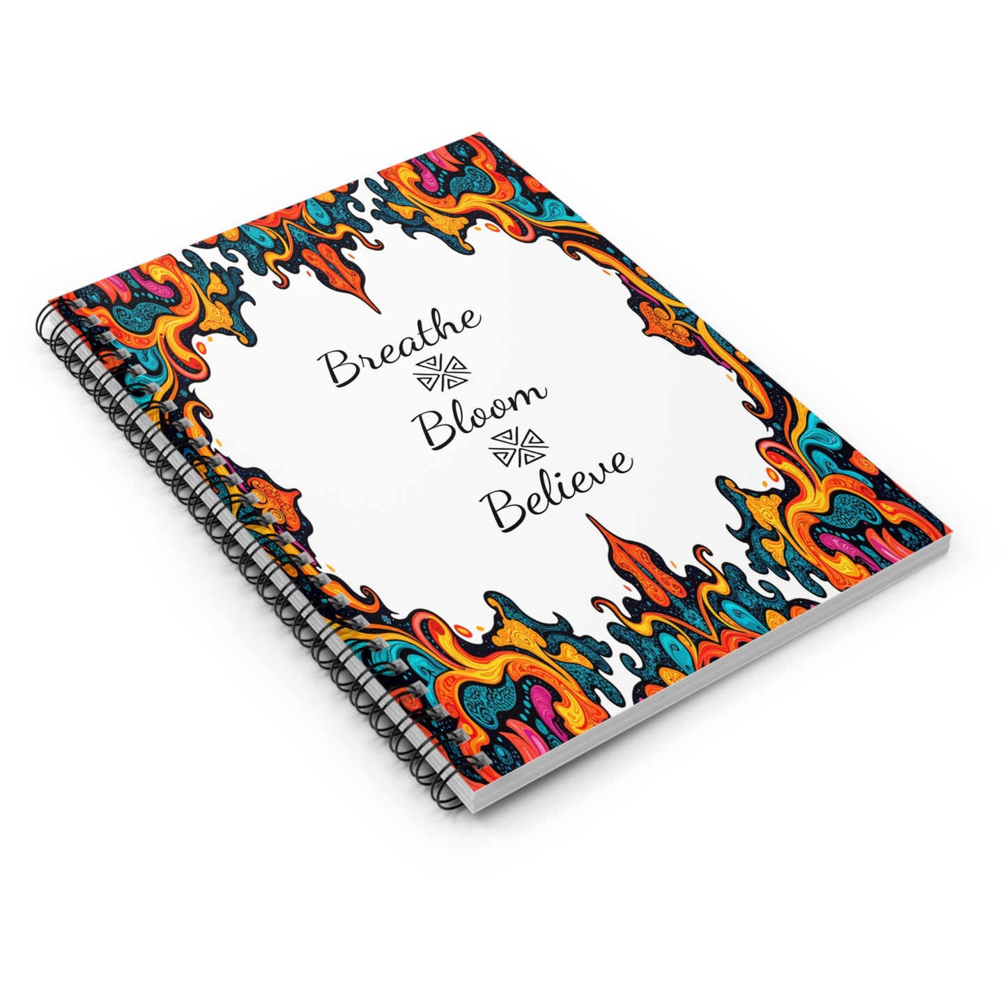 Spiral notebook with a white cover featuring vibrant, multicolored abstract flame designs on the borders. The center displays the words “Breathe Bloom Believe” in elegant black script, inspired by African geometric notebook patterns.